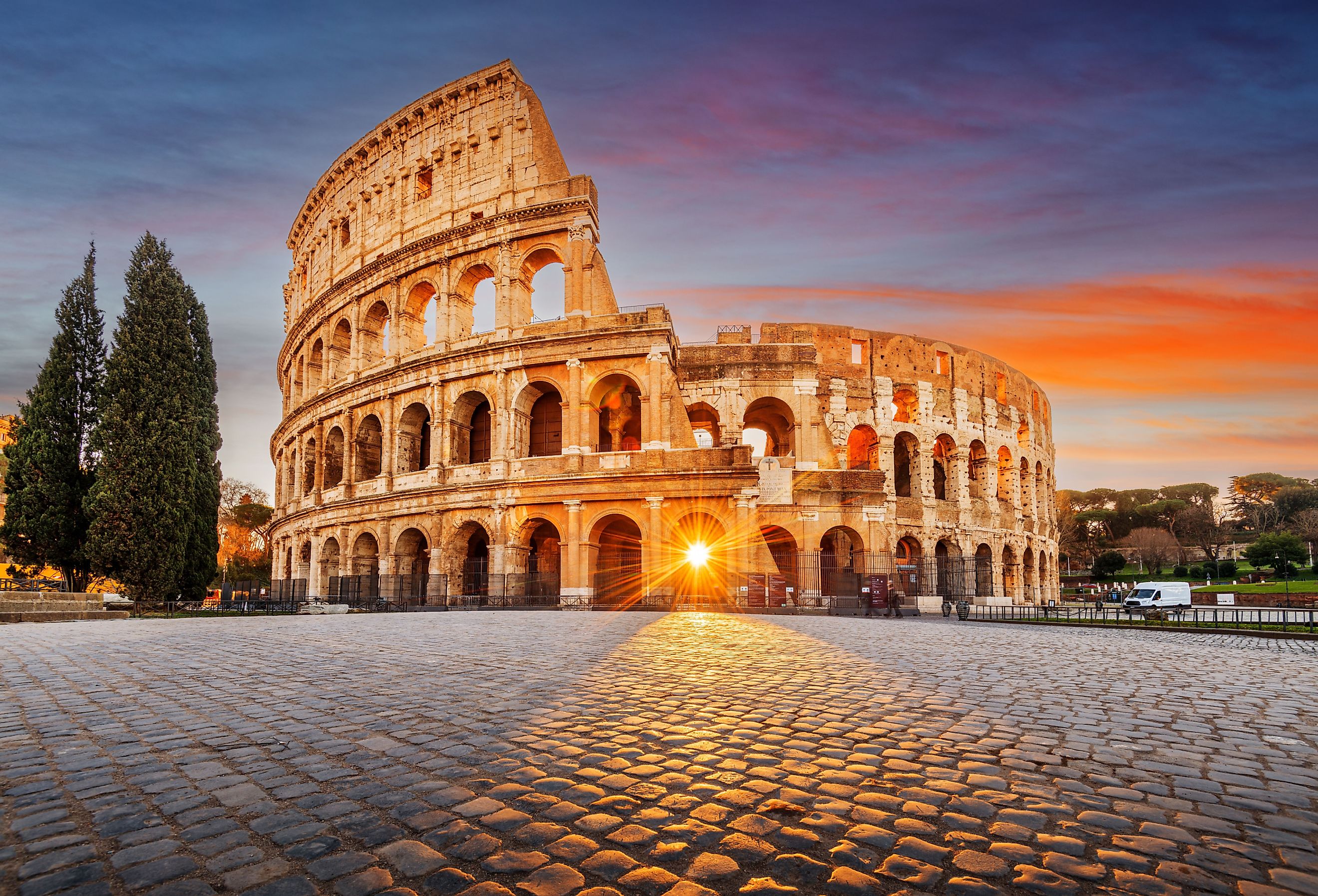 Rome, Italy at the Colosseum Amphitheater with the sunrise through the entranceway.