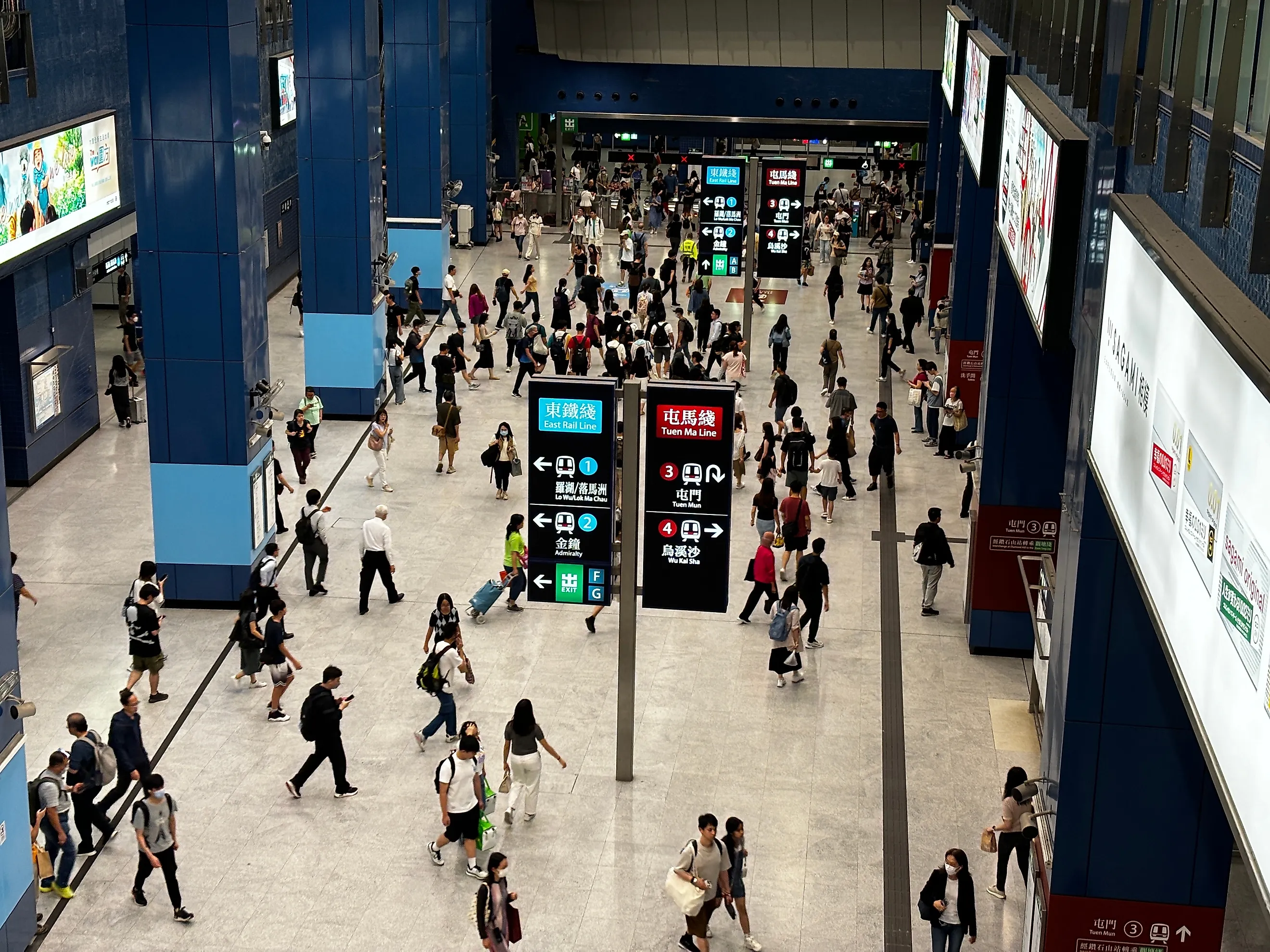 a bustling MTR (Mass Transit Railway) station in the Tai Wai area of Hong Kong. 