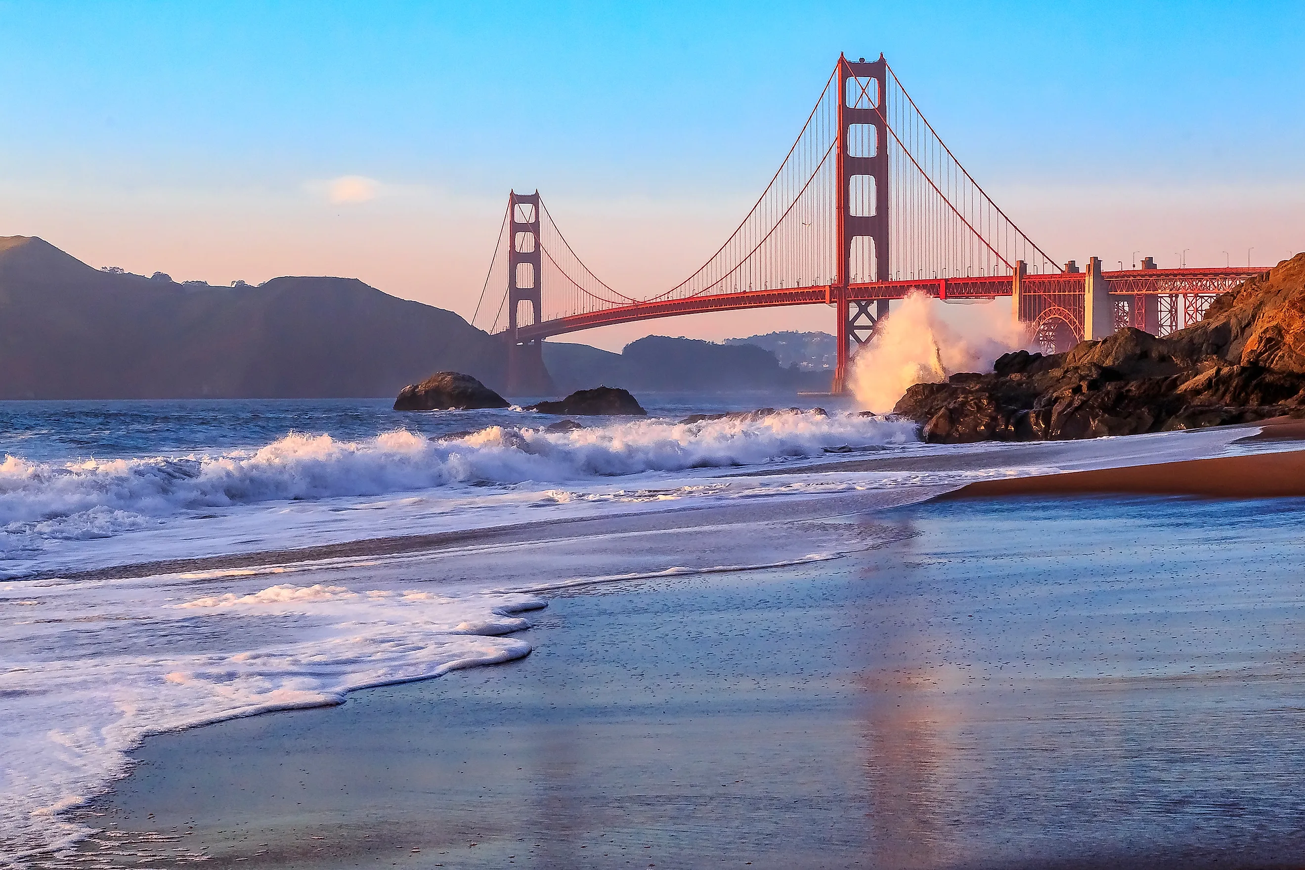 Famous Golden Gate Bridge view from Baker Beach at sunset in San Francisco, California. 