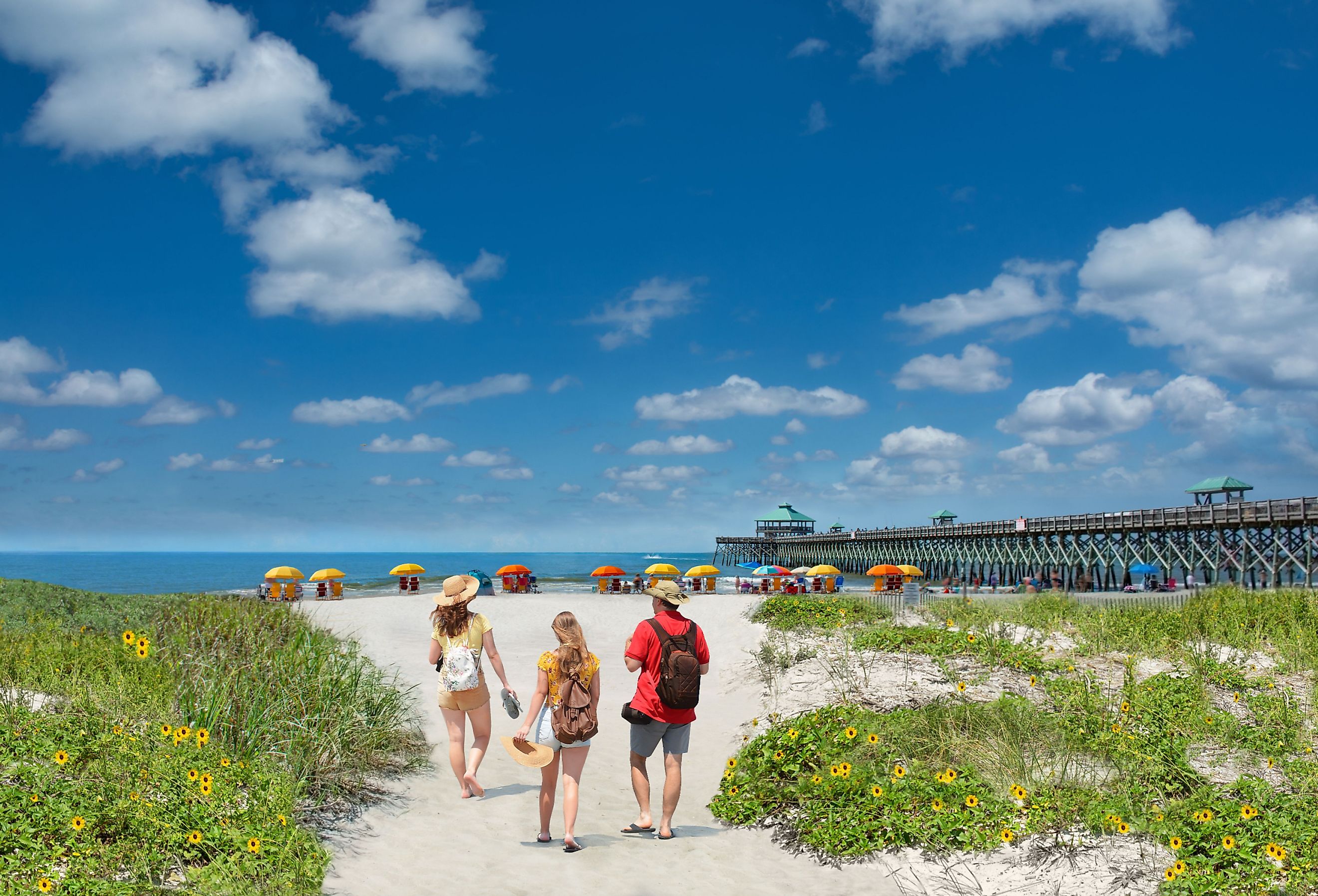  Family walking on Folly Beach, South Carolina USA.