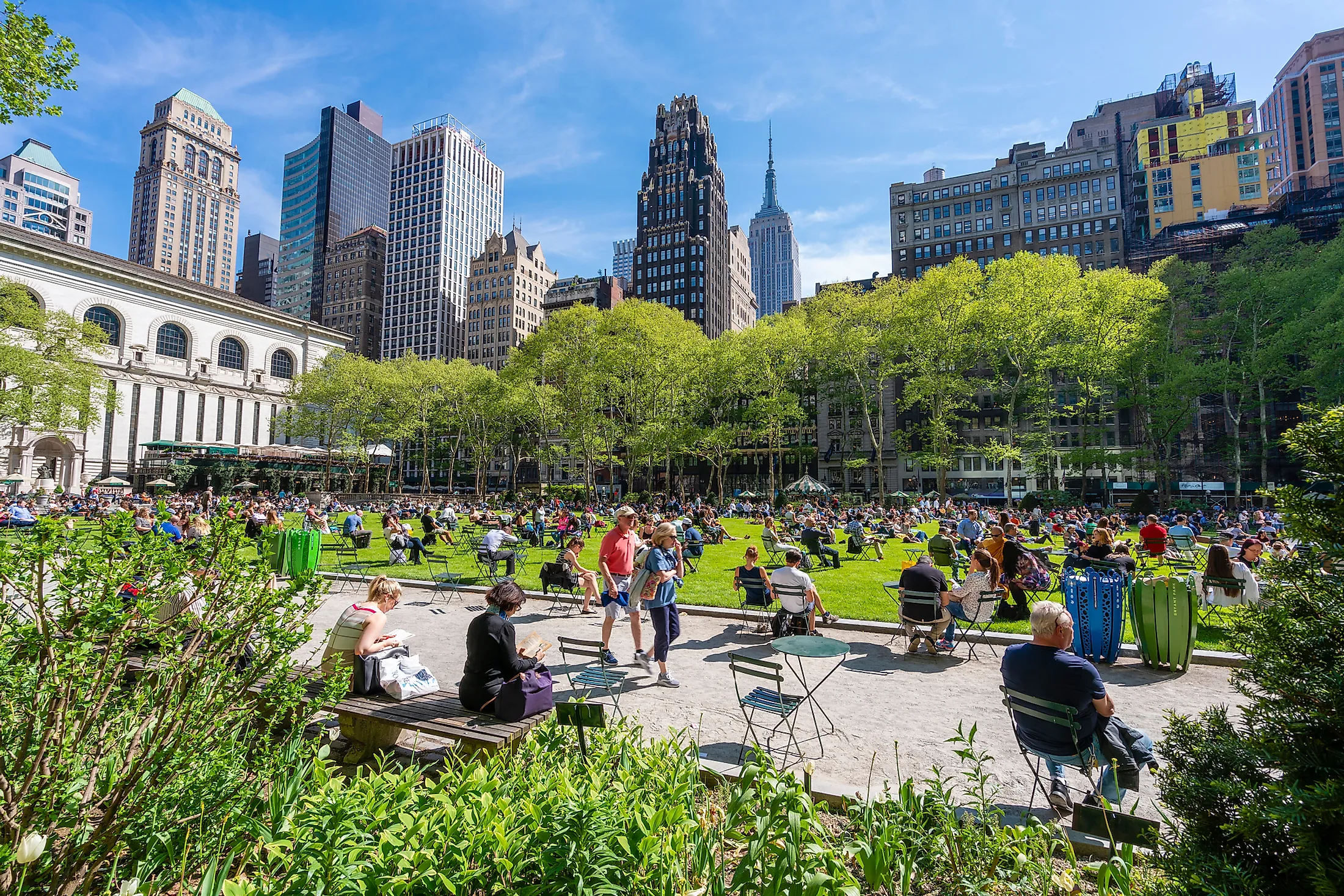 People relaxing at Bryant Park in Midtown Manhattan. Editorial credit: ymgerman / Shutterstock.com