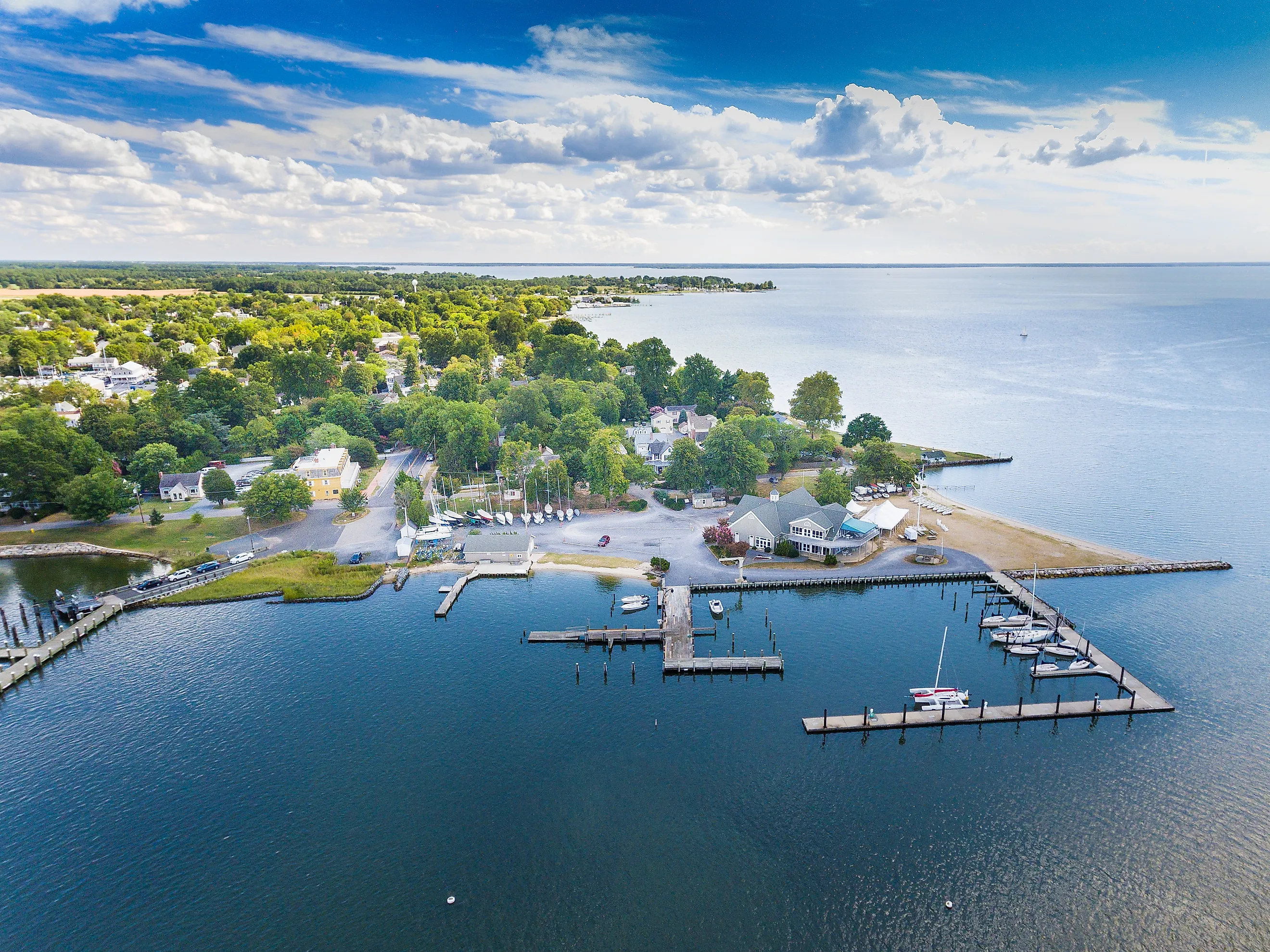 Aerial view of Oxford, Maryland, situated on the Chesapeake Bay, showcasing clouds, water, and shoreline.