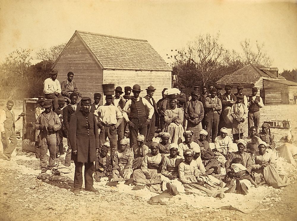 A Union soldier stands with African Americans on the plantation Thomas F. Drayton, Hilton Head Island, South Carolina, 1862. Photo by Henry P. Moore, May 1862.