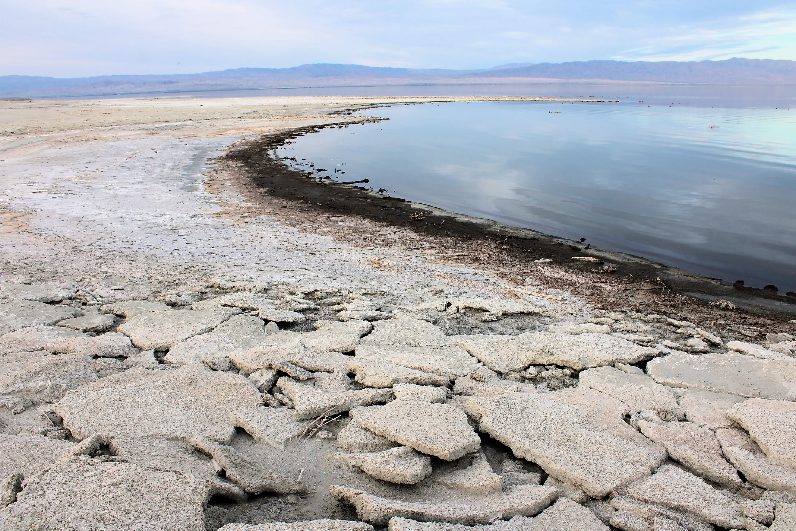 Salt crusts on a receded shoreline during a drought, taken at the Salton Sea in Salton City, California.