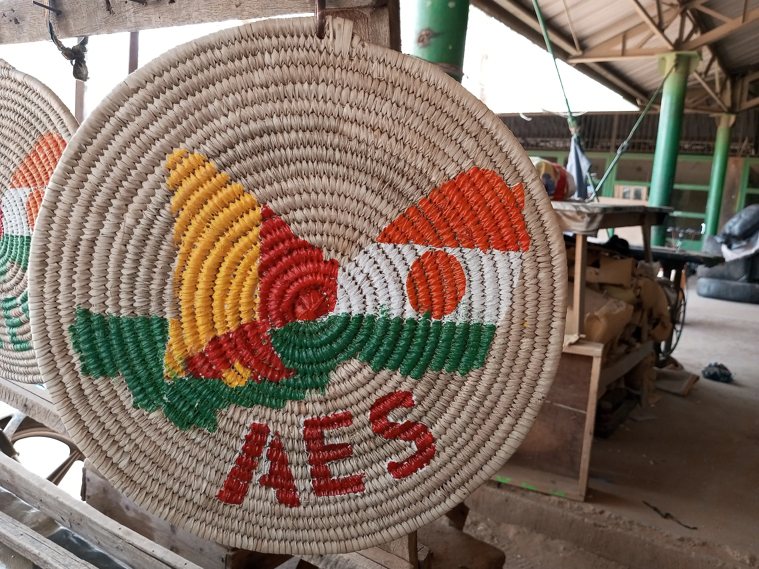 An artisan-made mat with an AES logo. By Barke11 - Own work, CC BY-SA 4.0, Wikimedia Commons.