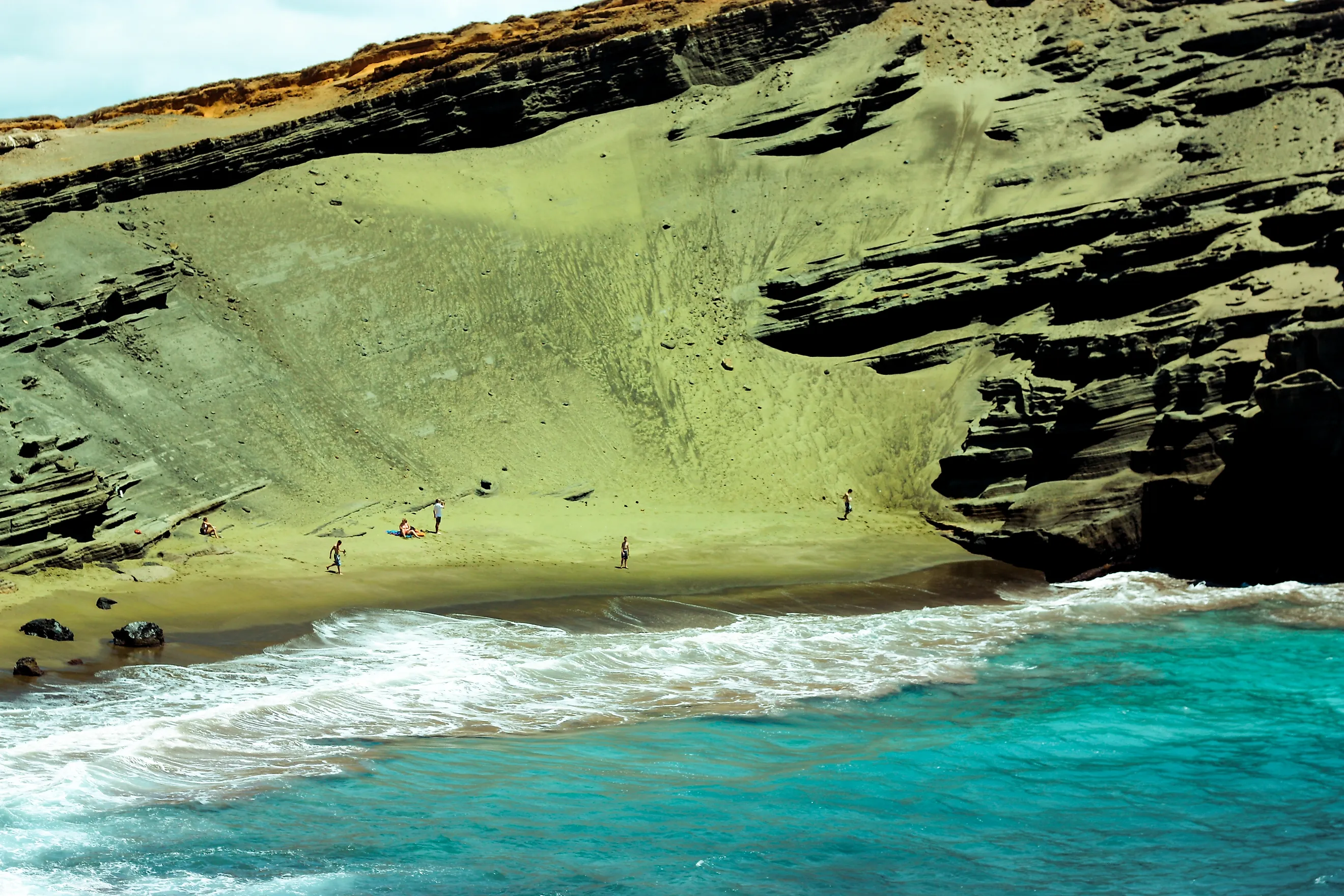 Editorial Photo Credit: Sej Saraiya via Shutterstock. Papakōlea (Green Sand Beach) in Big Island, Hawaii