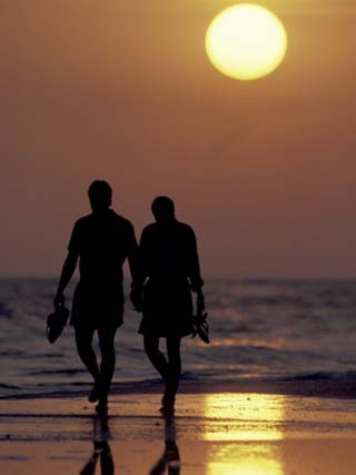 Couple Walking on Beach at Sunset, Sarasota, Florida, USA