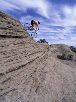 Active Male Rides Slickrock Ridge, Utah, USA