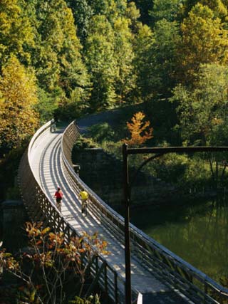 Cyclists Cross a Bridge on the Greenbrier Trail in West Virginia