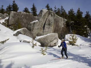 Woman Cross-Country Skiing Past Big Rocks in West Virginia