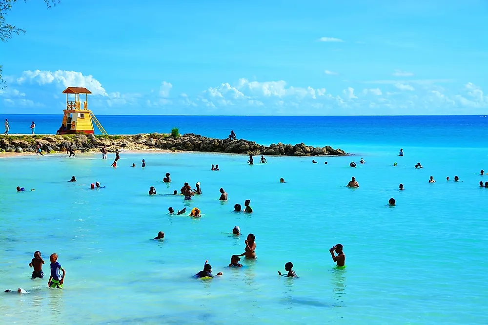People in the ocean in Barbados. Editorial credit: Styve Reineck / Shutterstock.com.
