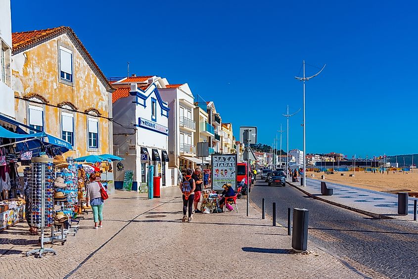 Cliffs and red-roofed houses above the Atlantic at Nazare, Portugal.
