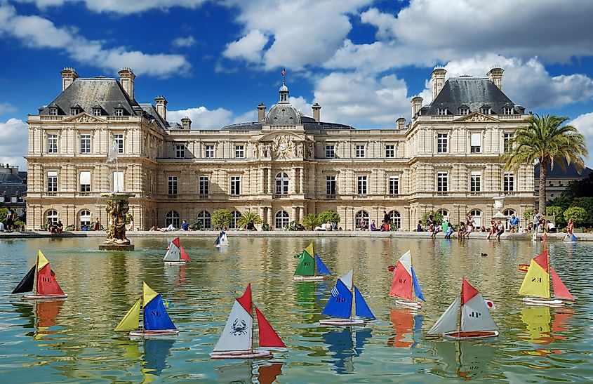 Paper boats floating in the lake by the Luxembourg Palace in the Luxembourg Gardens.