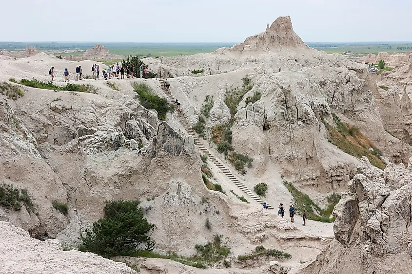 Interior, South Dakota: Hikers climbing the ladder of the Notch Trail at Badlands National Park.